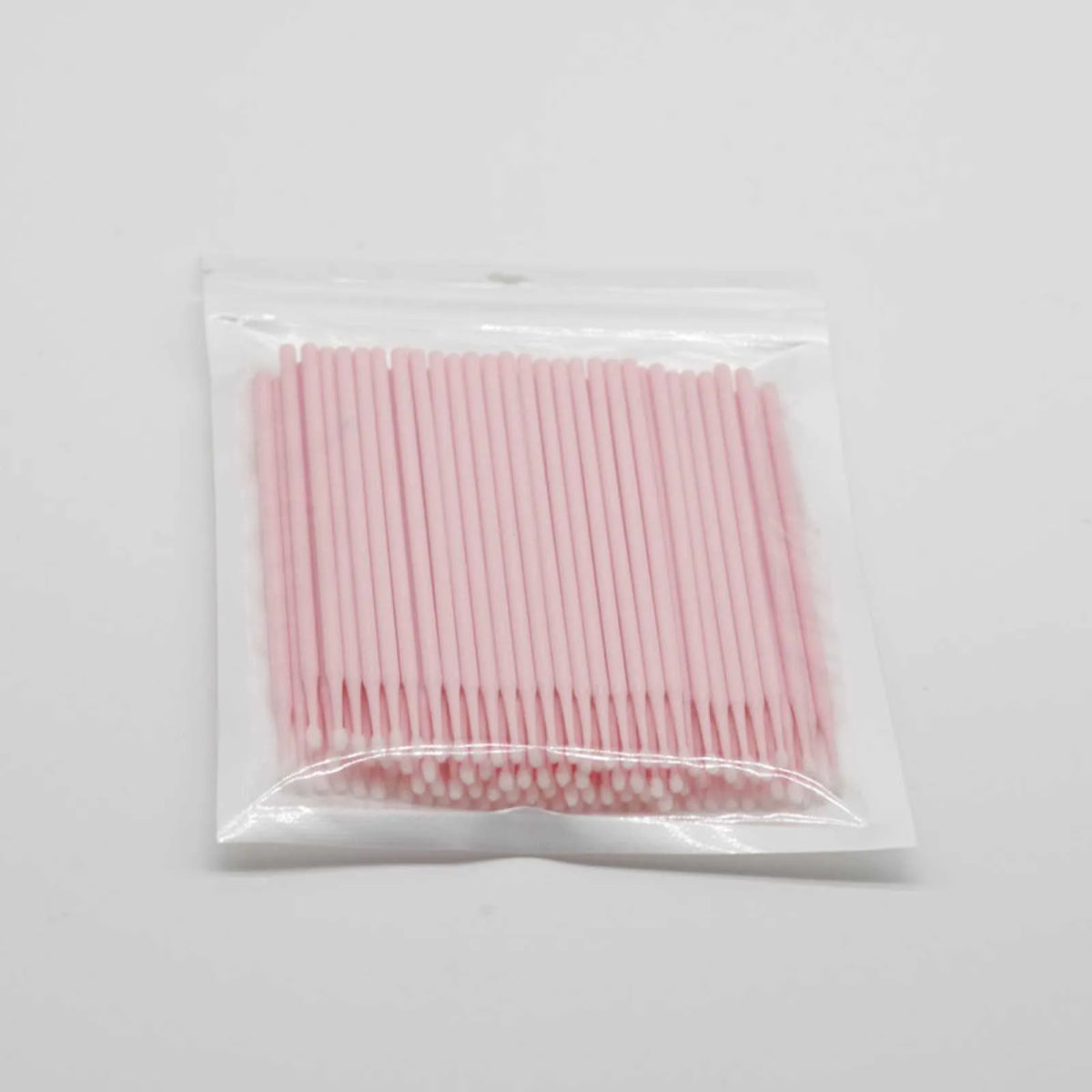 Disposable micro applicator brushes with bendable cotton swab heads and coloured handles for makeup and eyelash extensions