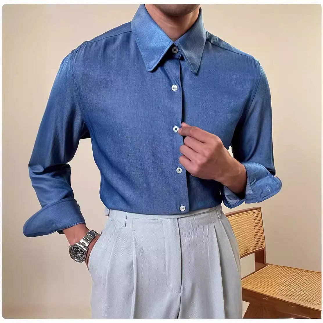 Man wearing a slim fit light blue long sleeve shirt with a round collar