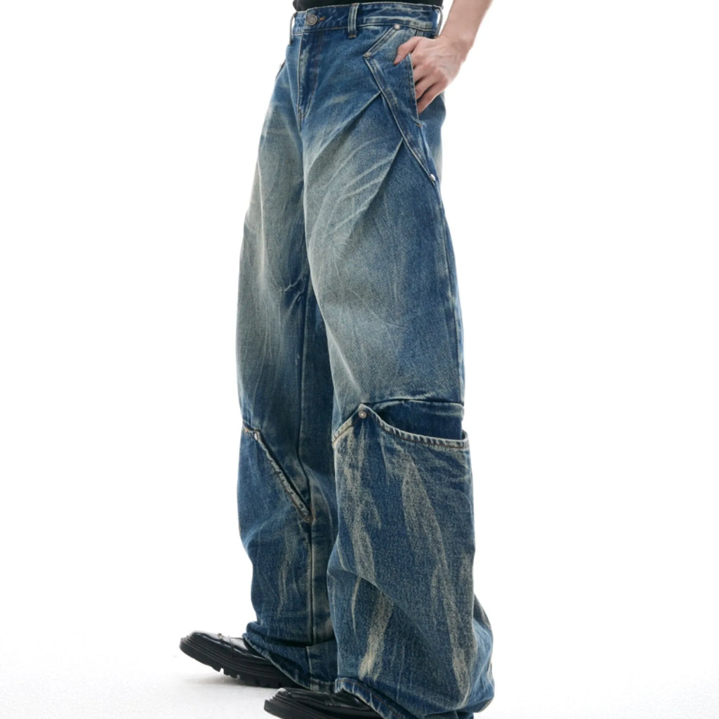 Men's verdant blue loose fit jeans showcasing a retro washed burst pattern and curved knife design details.