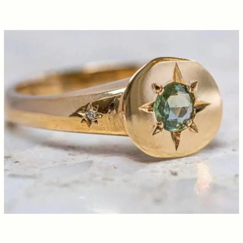 Gold coloured adjustable opening ring with star-shaped zircon design and oval profile