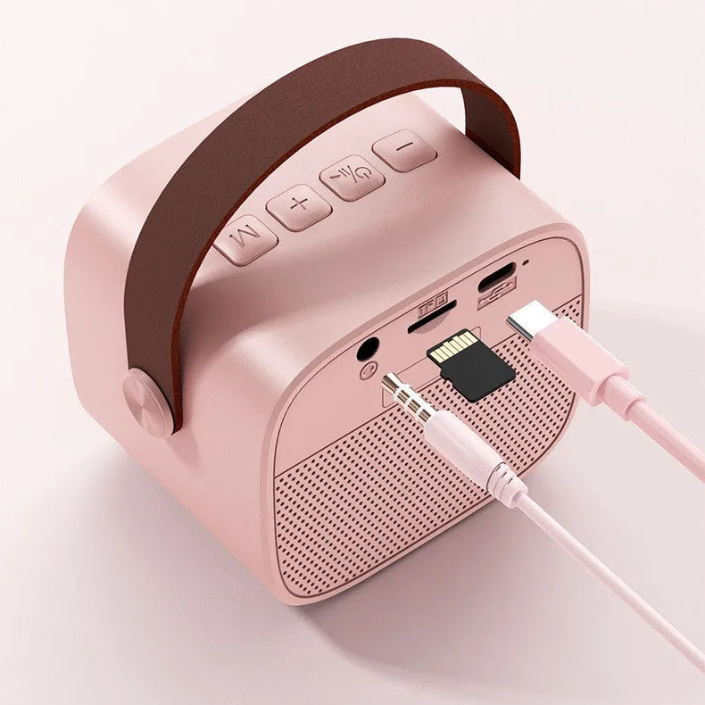 Compact white, pink, or blue portable Bluetooth speaker with microphone for hands-free calls.