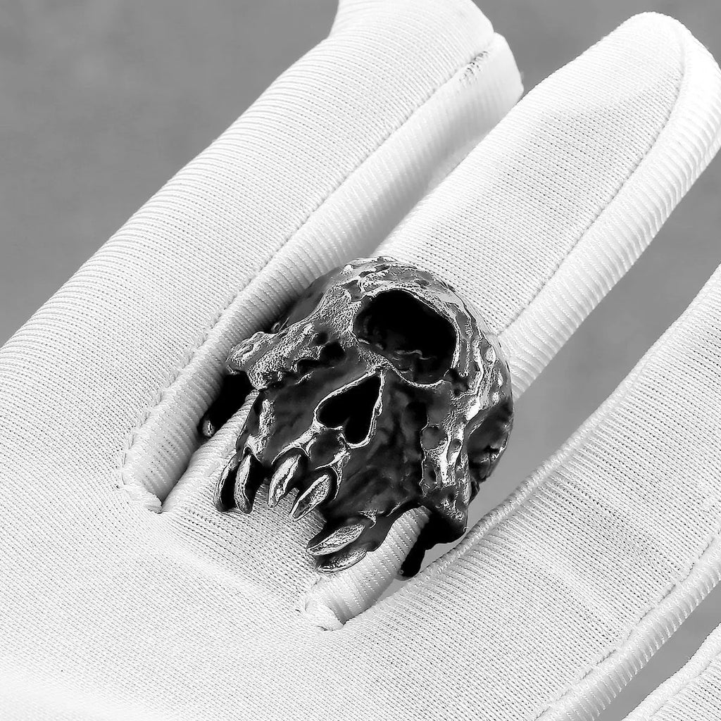 Alloy ring with a detailed one-eyed skull design on a finger, showing its metallic retro finish.