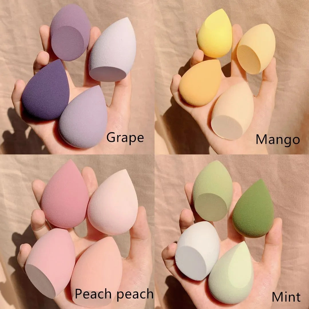 Four colourful makeup sponge eggs in grape, mango, mint and peach colours for cosmetic application