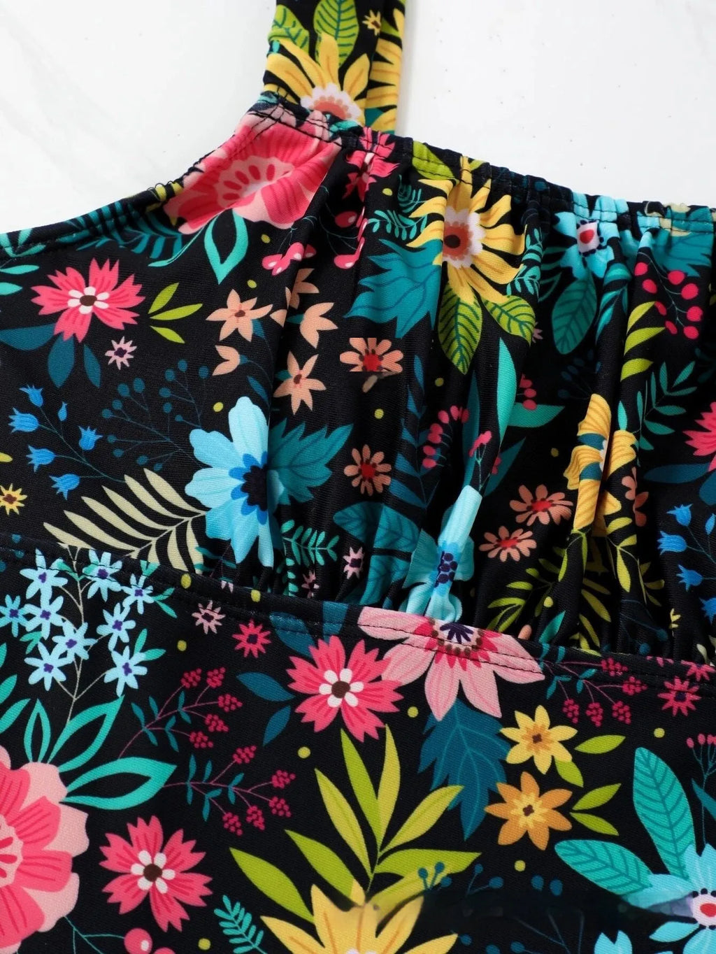 Women's floral print one-piece swimsuit with full back on mannequin.