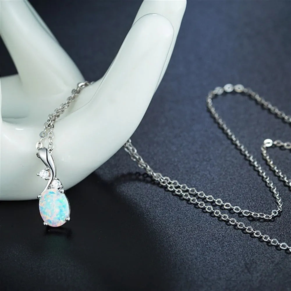 Water drop shaped opal pendant necklace on an O-chain in rose gold or white finish.