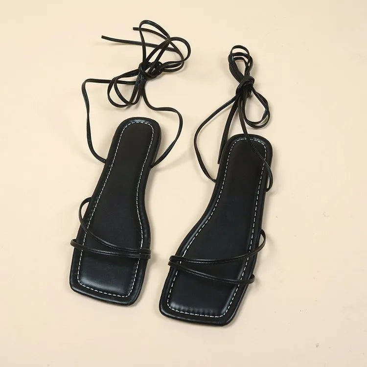 Women's flat sandals with ankle ring bandage detail and front lace-up closure in solid colour