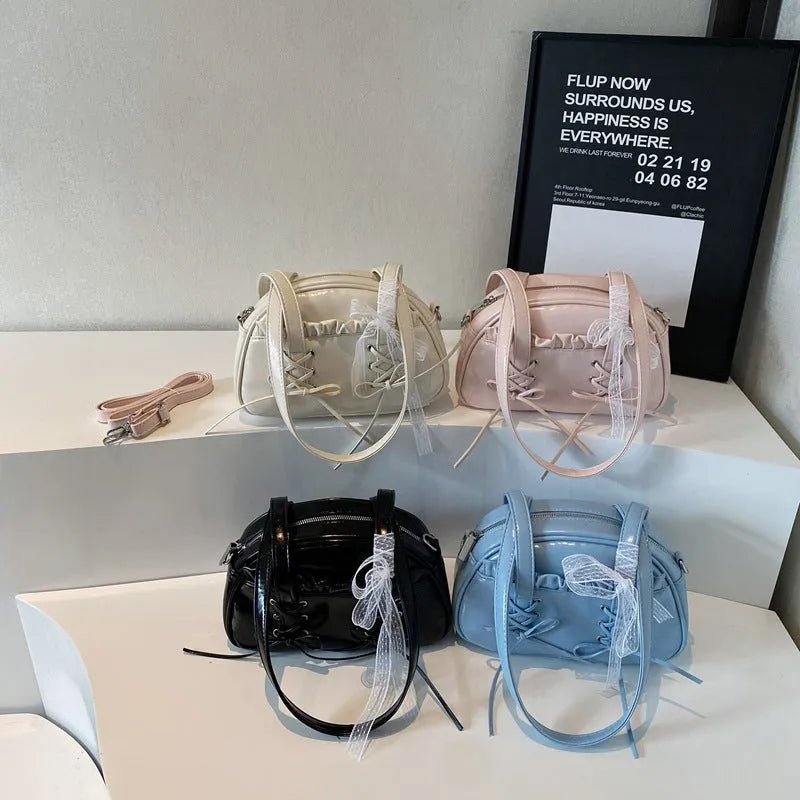Women's milky white PU shoulder bag with bandage bow and stitching detail, showing internal phone pocket.
