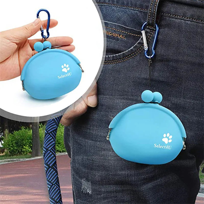 Blue silicone dog treat pouch with hook and loop closure, shown attached to a waistband.