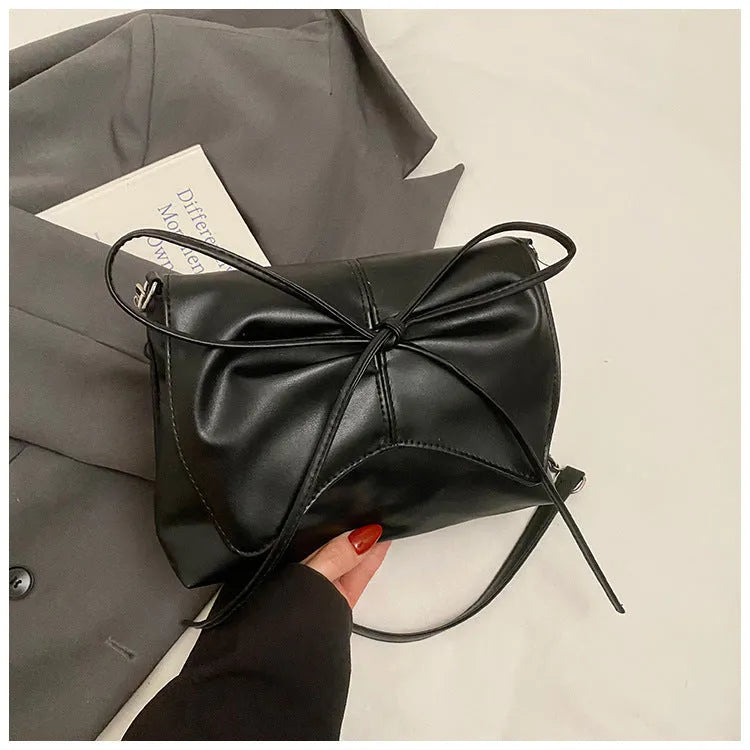 Women's black PU crossbody underarm bag with horizontal square shape and visible sewing line detailing