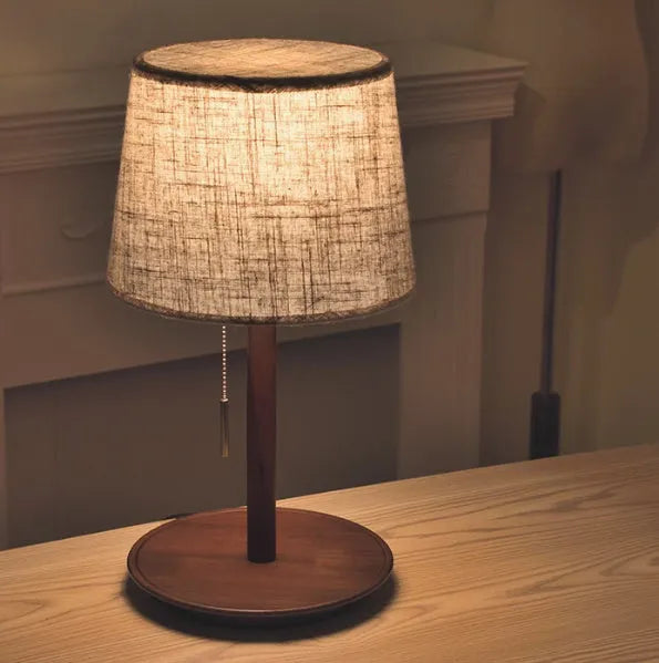 Walnut colour solid wood bedside lamp with white cloth shade and cable switch