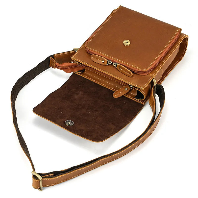 Men's brown cowhide leather crossbody bag with flip shoulder strap and retro style.