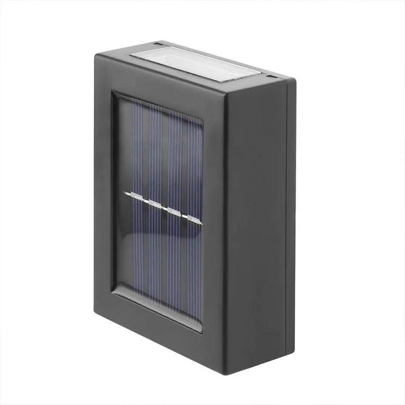 Solar-powered garden wall light mounted on outdoor brick wall illuminating pathway at night