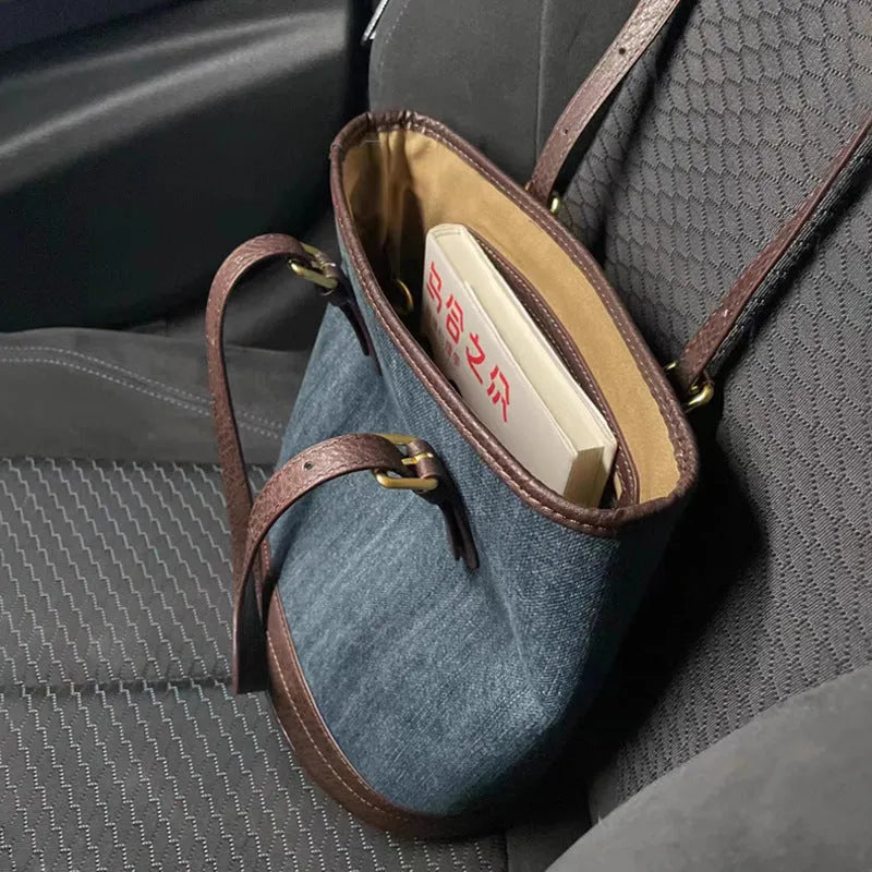Denim patchwork one-shoulder bucket handbag with large open top, shown in denim commuter colour.