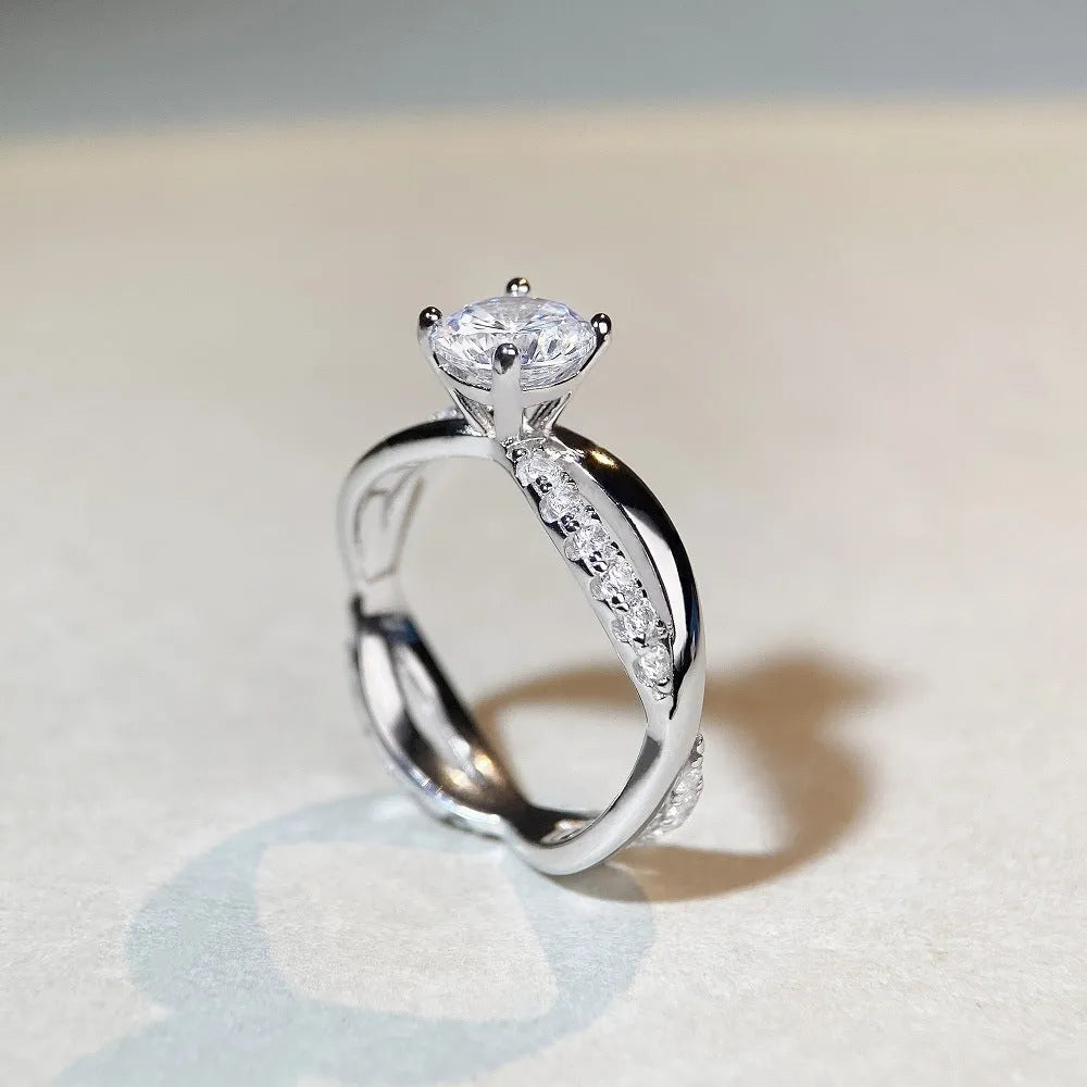Silver twisted arm ring with a 1 karat moissanite stone in a four-claw setting.
