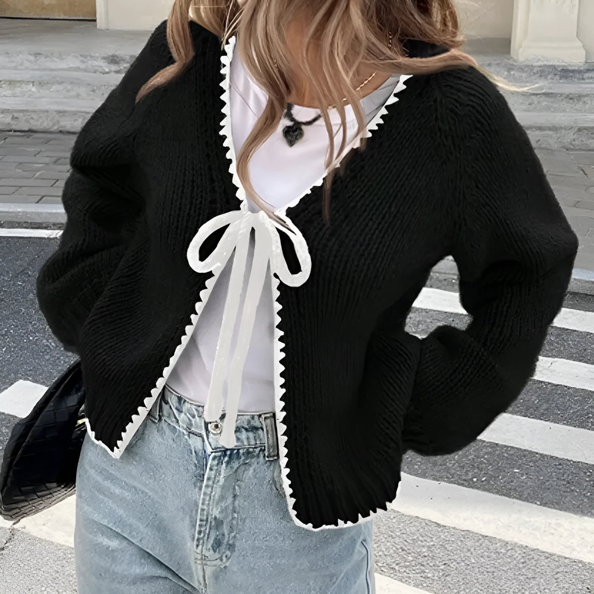 Women's grey lace-up cardigan sweater with crochet flower detail on front