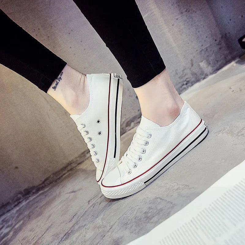 Women's solid-colour canvas lace-up trainers on a white background, showing the casual design and lace detail.