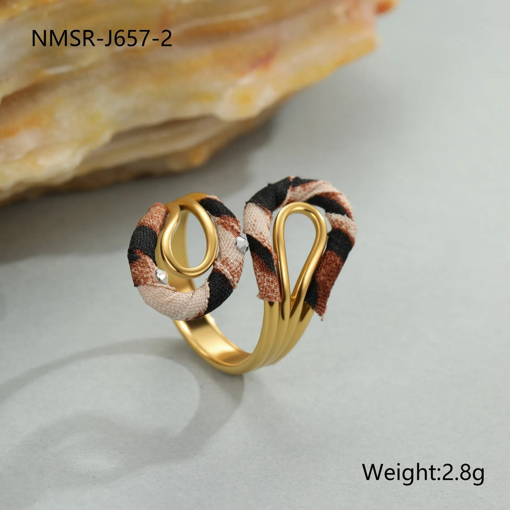 Leopard print geometric open mouth stainless steel ring on a grey background.