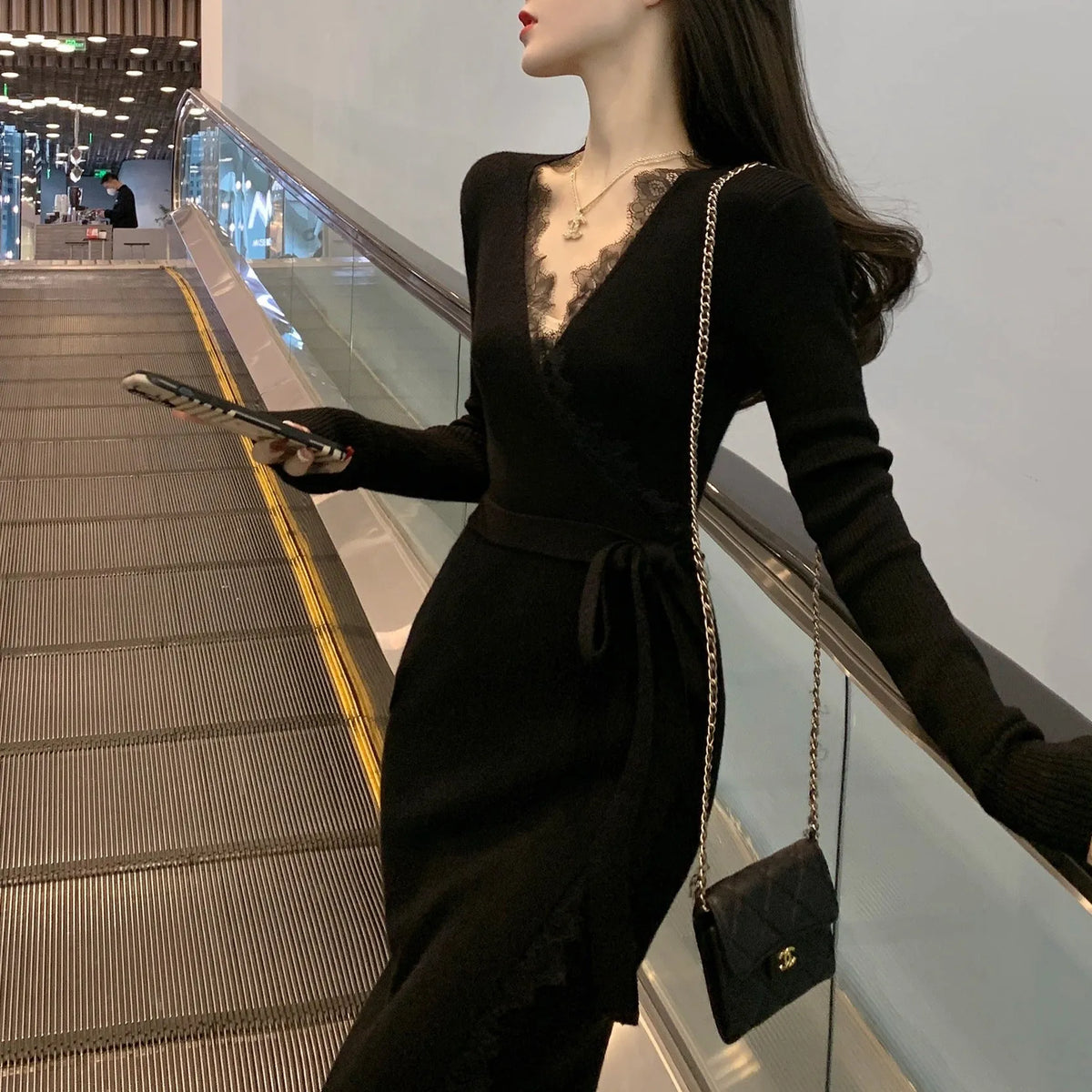 Black women's slim fit woolen skirt dress with princess silhouette on hanger