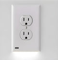 White plastic socket induction LED night light plugged into a wall outlet