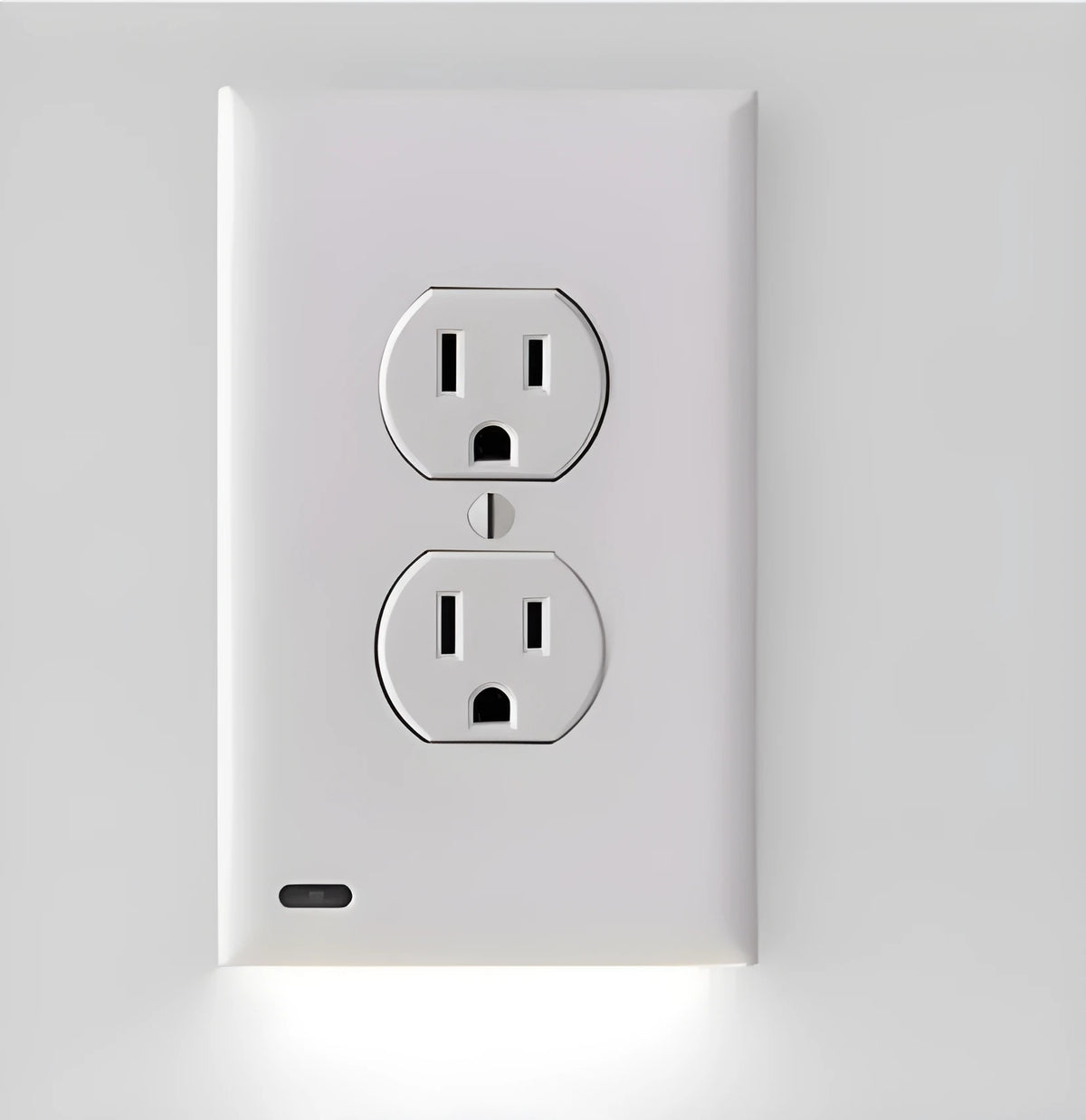 White plastic socket induction LED night light plugged into a wall outlet