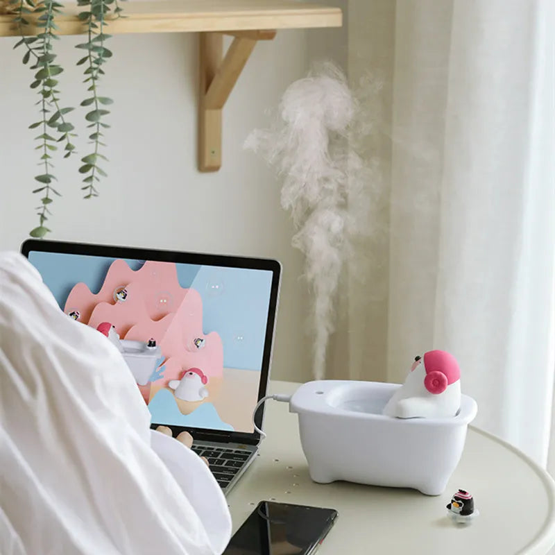 White USB air humidifier and scent diffuser with large water tank on a desk.