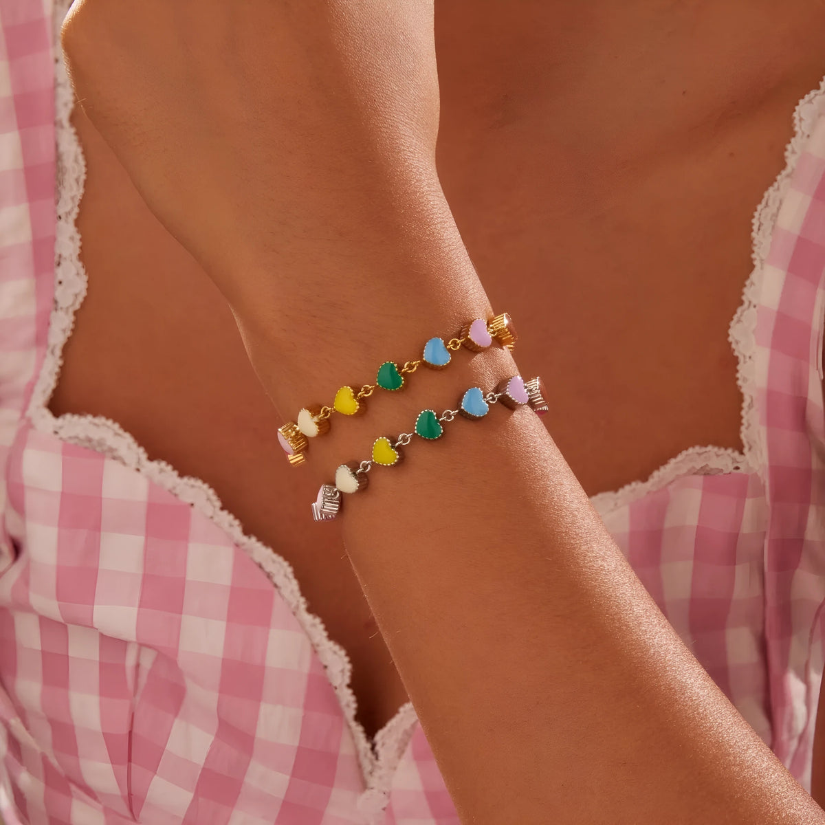 Women's heart-shaped stainless steel bracelet with 18K electroplated finish in gold or steel tone.