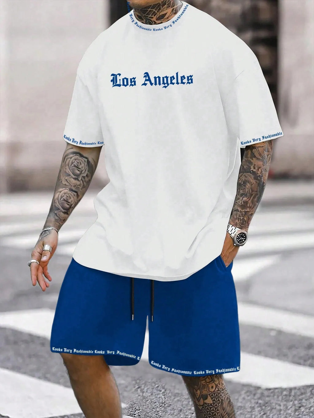 Mens blue sports style short sleeve top and shorts two-piece set on a plain background.