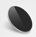 Ultra-thin aluminium wireless charging pad in metallic finish with smartphone charging on surface
