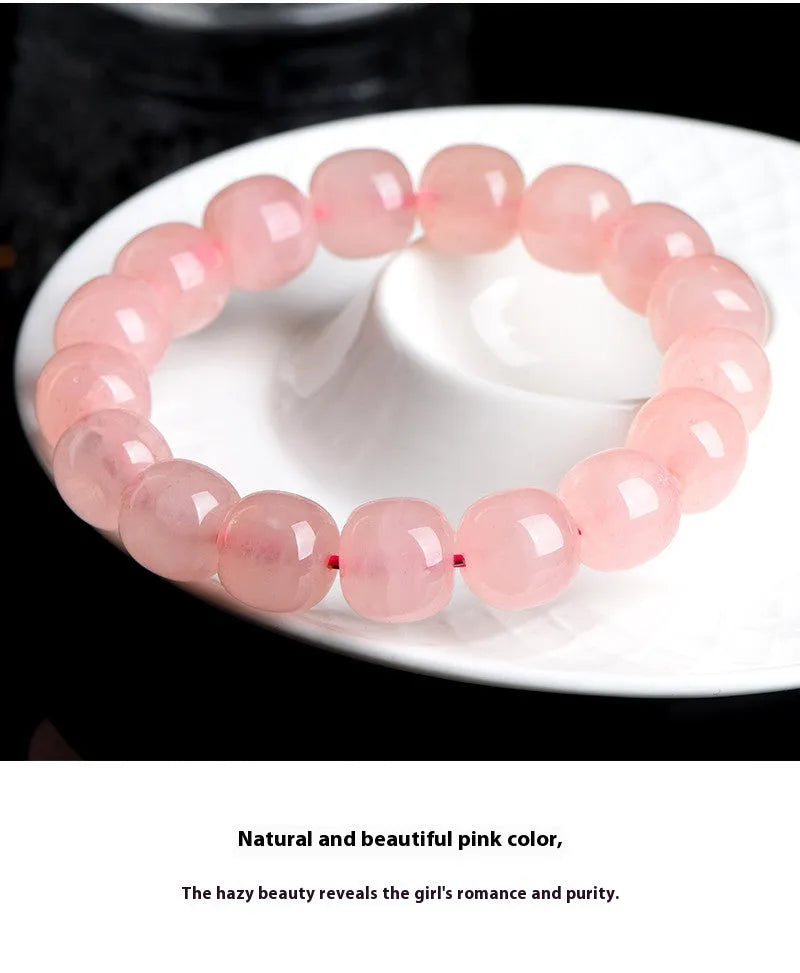 Pink natural crystal barrel bead bracelet with polished 8-10mm gemstone beads on wrist