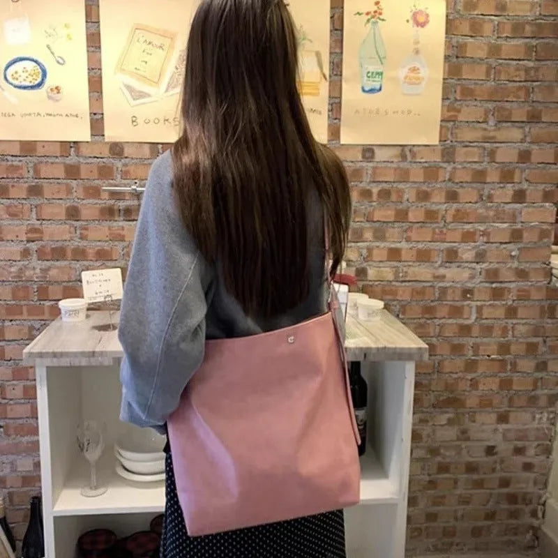 Pink corduroy one-shoulder crossbody bag showing front view and size.