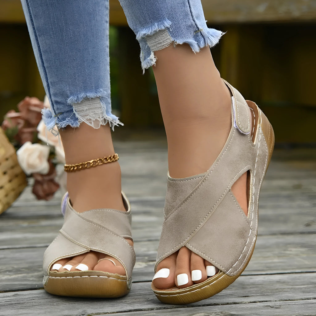 Women's brown Roman platform sandals with an open toe and Velcro strap closure on a rubber sole.
