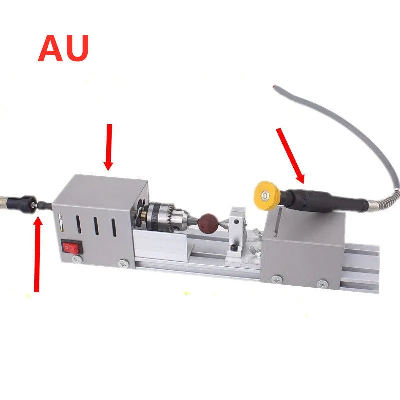 Mini metal manual woodworking lathe with carving knives on a workshop bench