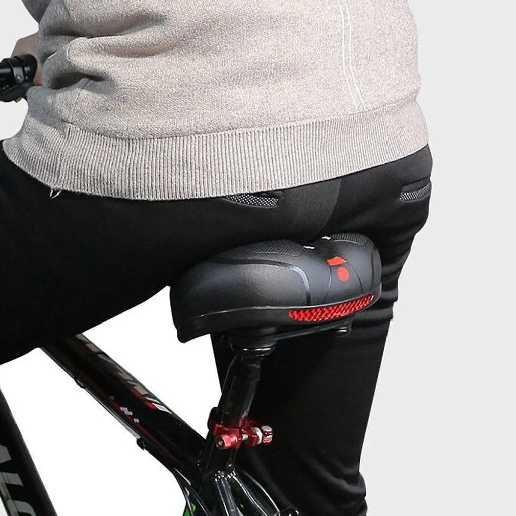 Hollow seat cushion bicycle saddle with PU leather cover, memory foam pad, and PP base, 26x21cm, in blue, red, or yellow.