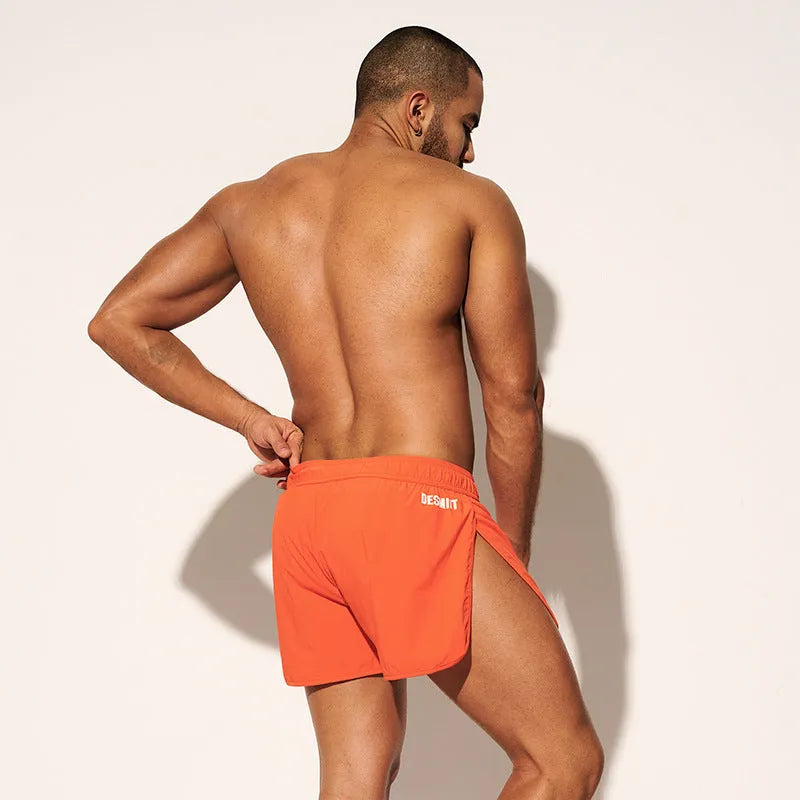 Men's elastic waist beach shorts in black, fluorescent green, or orange red colours for surfing and swimming