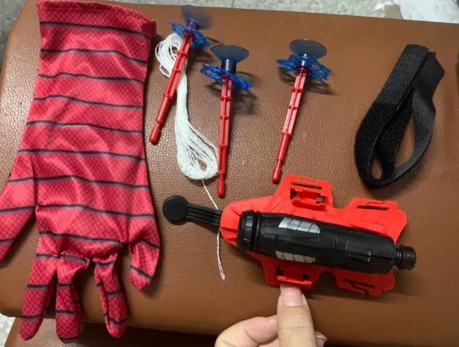 Plastic spider launcher wrist transmitter toy in green with one-size-fits-all fit and glove option