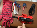 Plastic spider launcher wrist transmitter toy in green with one-size-fits-all fit and glove option