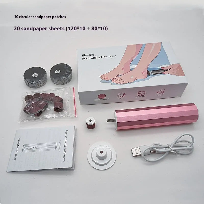 Pink USB-powered electric callus remover tool with sandpaper discs on a table.