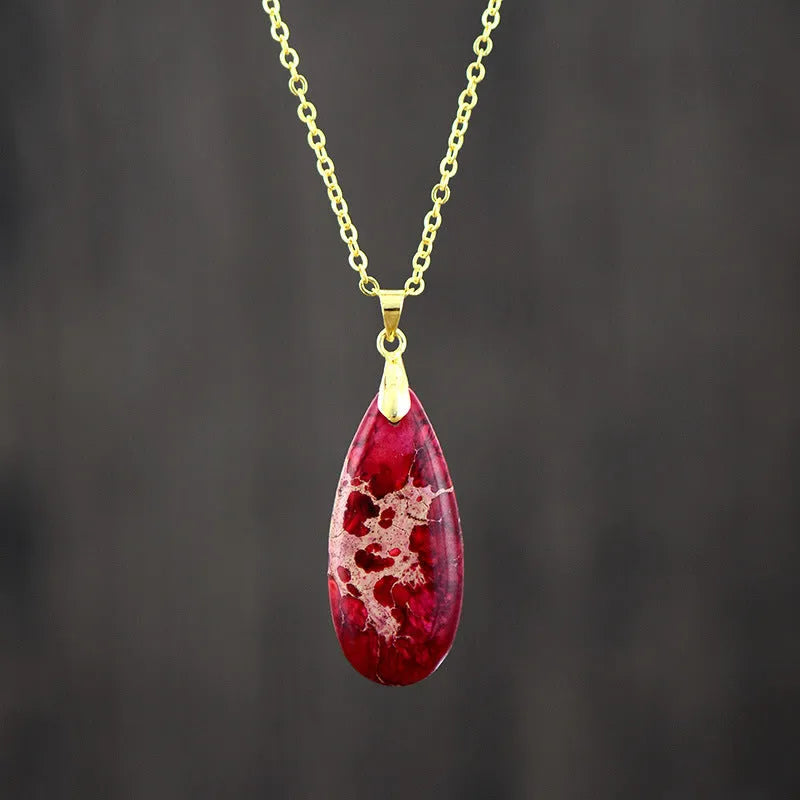 Water drop shaped emperor stone jade pendant on an 18K gold plated chain necklace.