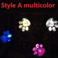 Black bear paw-shaped solar garden lights illuminating a garden path at night