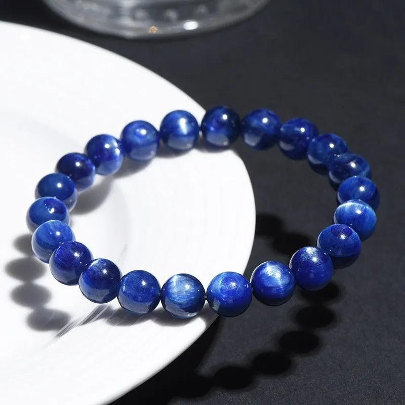 Natural blue crystal bead bracelet with geometric design and polished finish on a wrist.