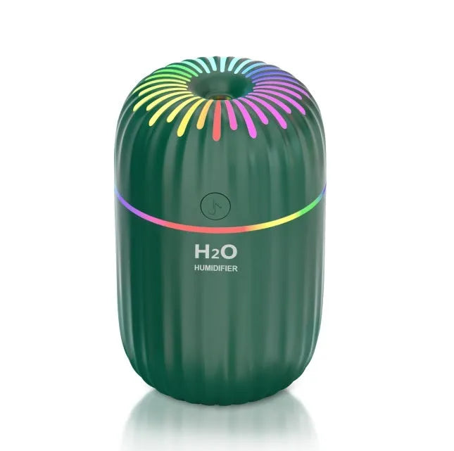 Small white USB humidifier with 300ml tank on desk next to laptop
