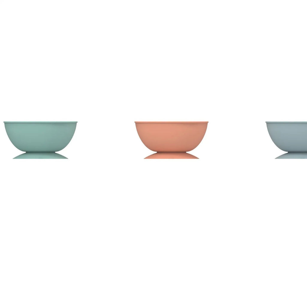 Cyan edible silicone dog slow feeder bowl with licking mat texture and suction cup base.