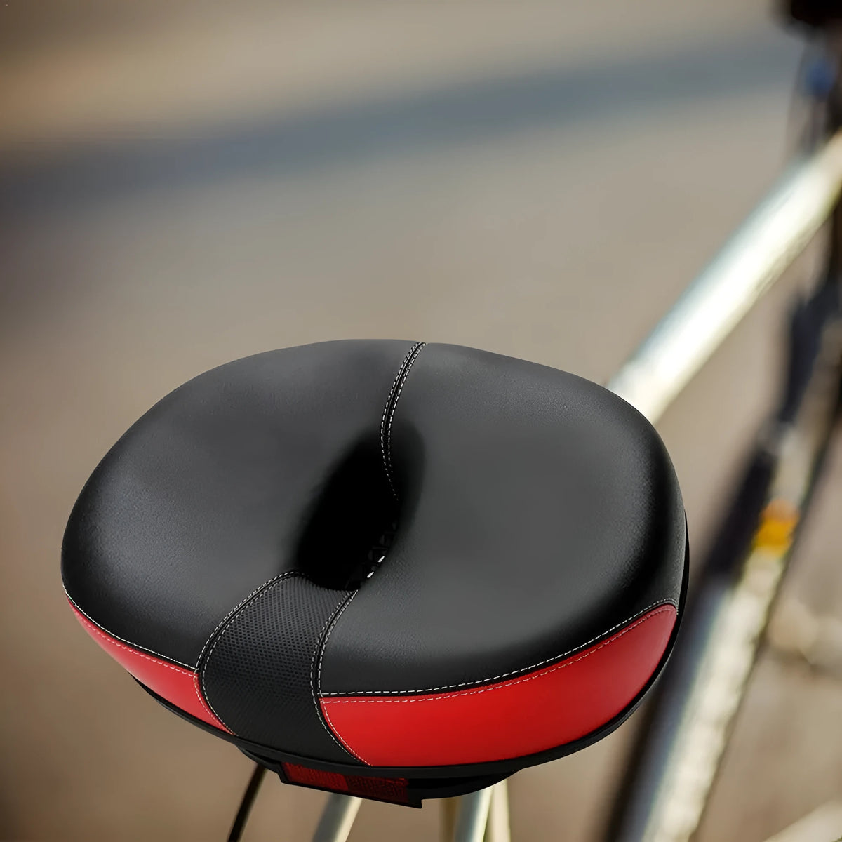 Large red bicycle saddle with thickened padding and reflective elements for ordinary bicycles