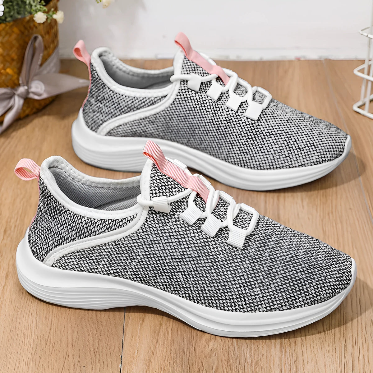 Women's low-top casual sneaker in mesh fabric with round toe and flat sole, shown in black.