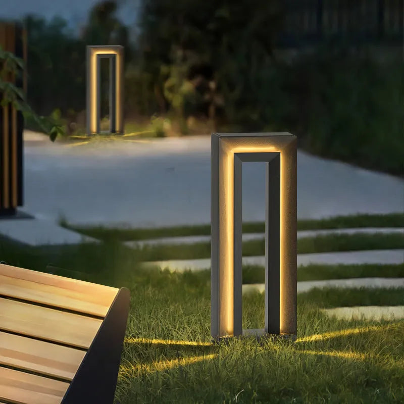 A modern square-shaped stainless steel and acrylic outdoor garden lamp with a geometric design.