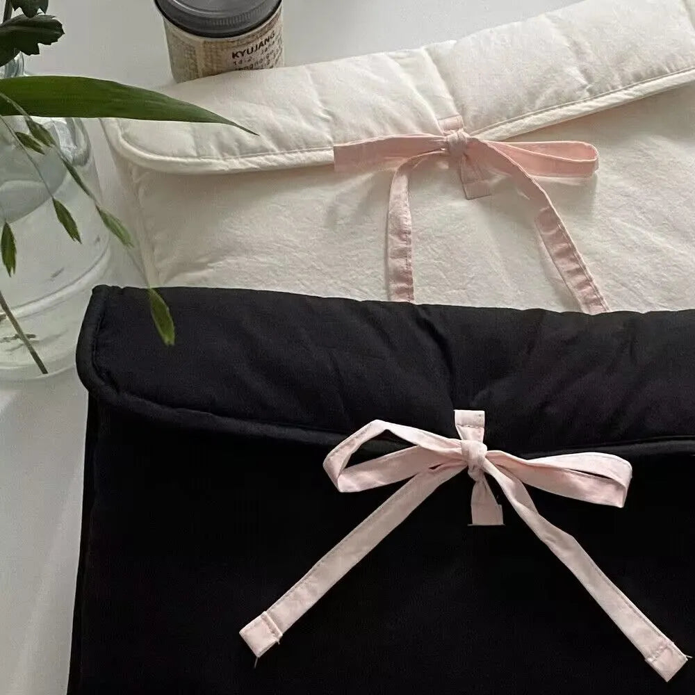 Women's black quilted computer bag with ballet style bow and striped pattern