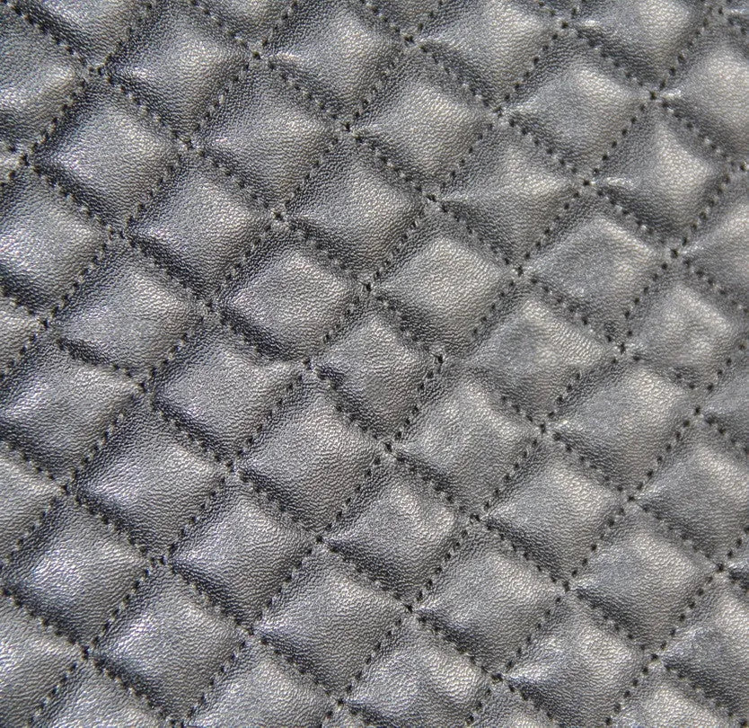 Black quilted automotive seat cover with PU polyester construction and sponge padding including plastic mounting hooks