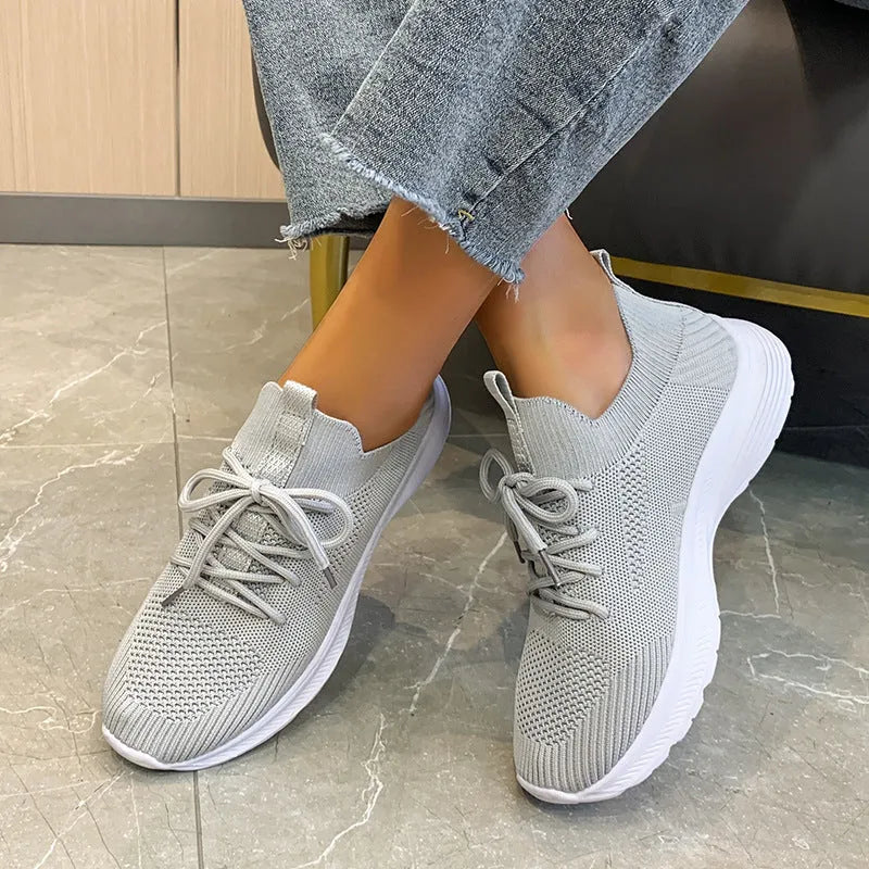 Women's creamy white mesh running shoes with flyknit upper and flat rubber sole