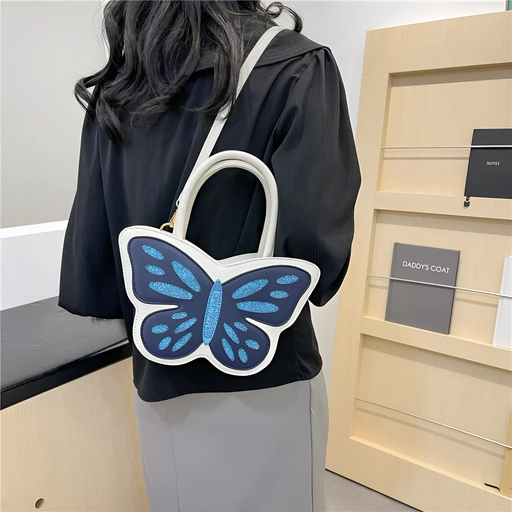 Small square crossbody bag in PU material showing contrast colour detailing and adjustable strap