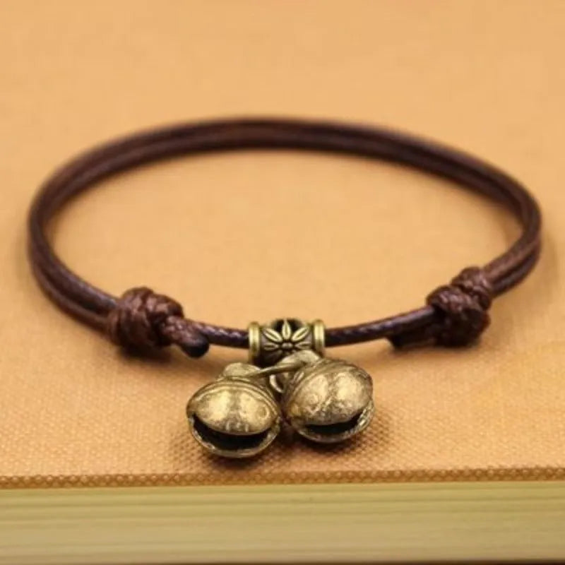 Nylon dog collar with brass bell shown in black rope colour, suitable for small to medium dogs.